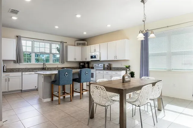 a kitchen with a sink window and cabinets