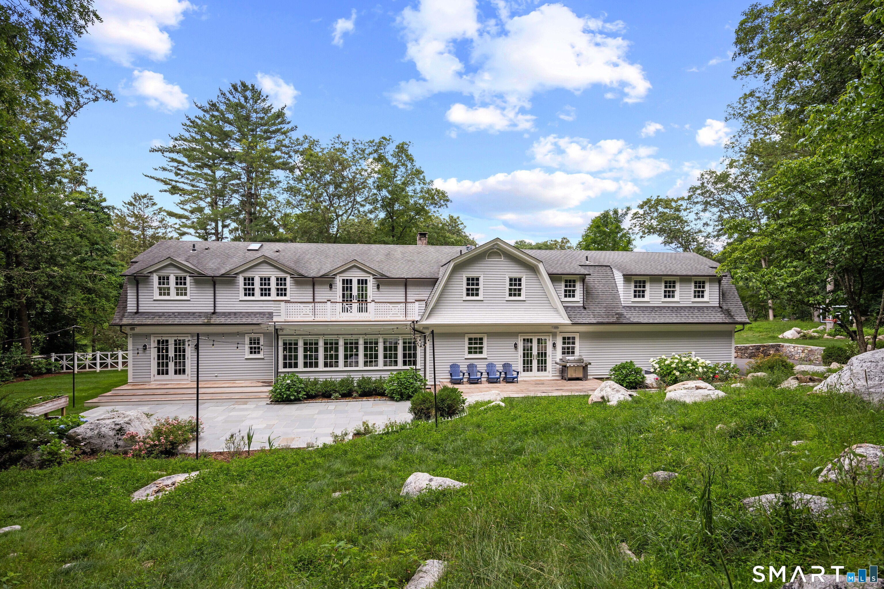 99 Hickok Road New Canaan, CT 06840 - Photo 33 of 39 a view of a house with a big yard potted plants and large tree