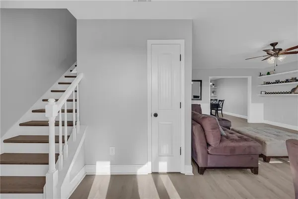 a living room with furniture and stairs