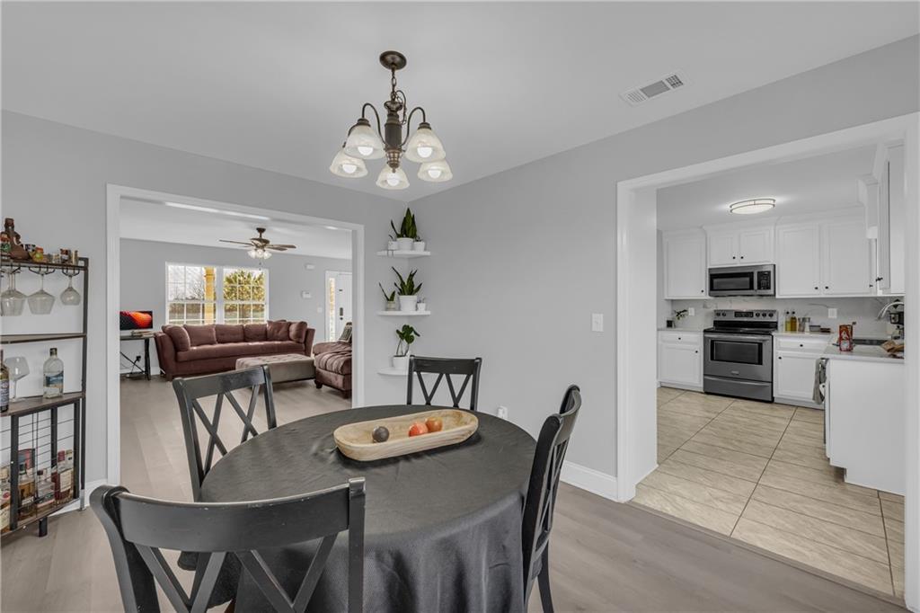 3455 Navigator Lane Gainesville, GA 30507 - Photo 6 of 19 a view of a dining room with furniture and wooden floor
