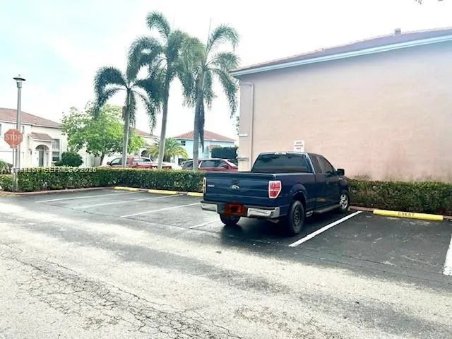 a view of a street with a car parked on the road