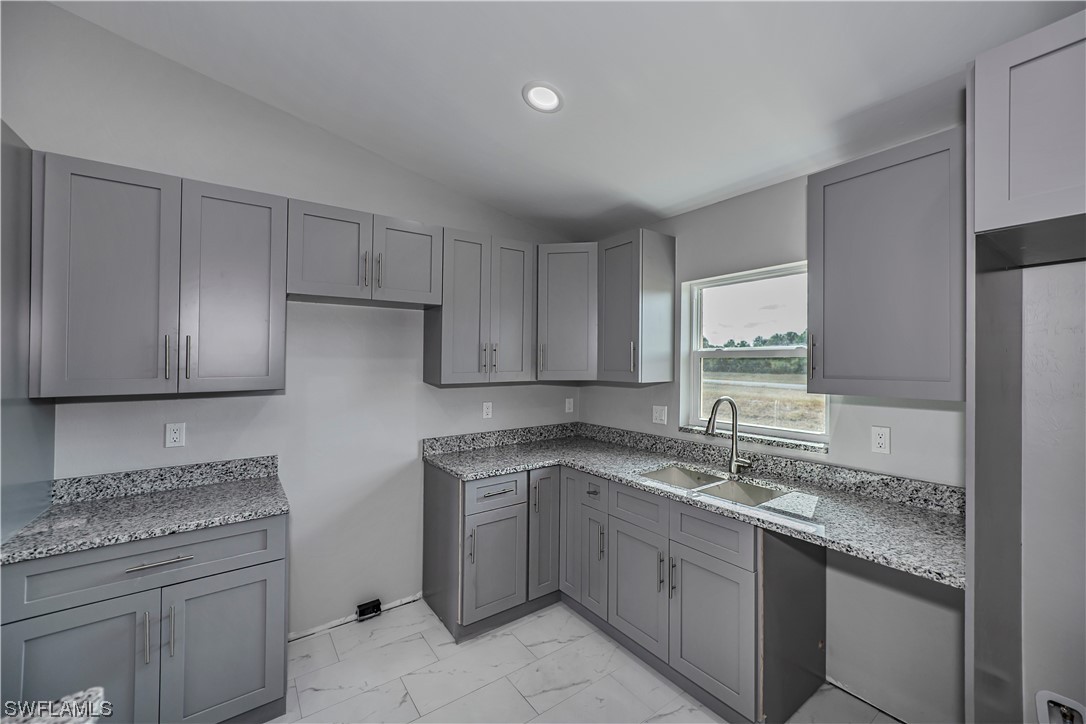9035 West Crow Circle LaBelle, FL 33935 - Photo 11 of 32 a kitchen with a sink stove and cabinets