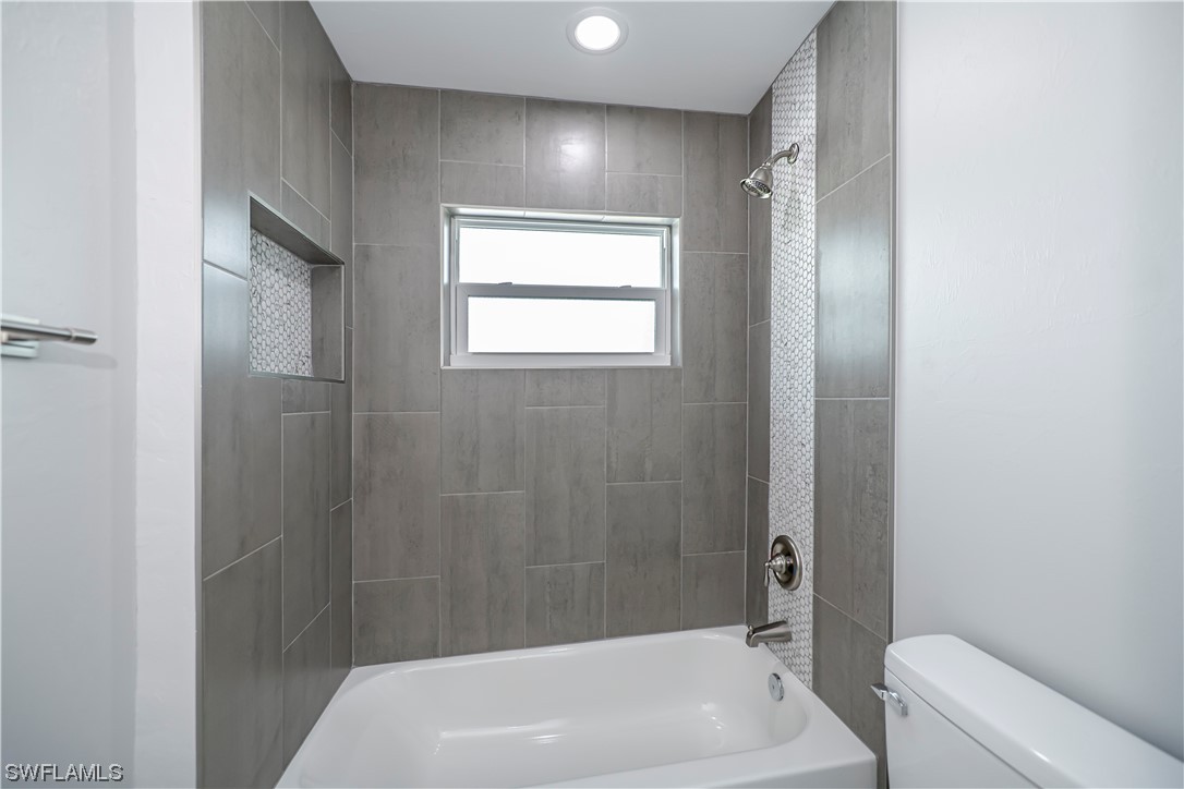 9035 West Crow Circle LaBelle, FL 33935 - Photo 28 of 32 a bathroom with a white bath tub a toilet and a sink