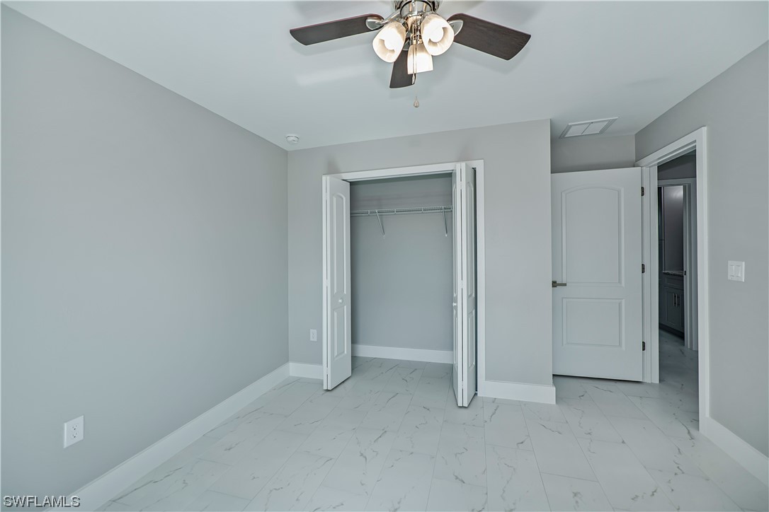 9035 West Crow Circle LaBelle, FL 33935 - Photo 32 of 32 a view of an empty room with a chandelier fan