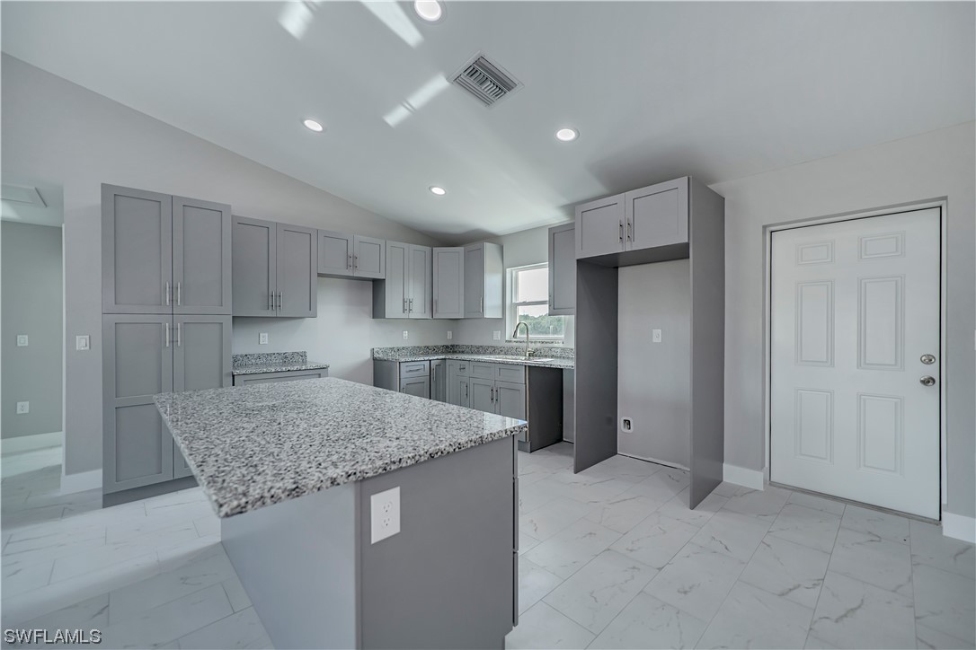 9035 West Crow Circle LaBelle, FL 33935 - Photo 9 of 32 a kitchen with stainless steel appliances granite countertop a sink and a refrigerator