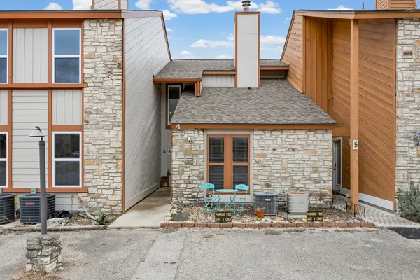 a brick building with a bench and a table