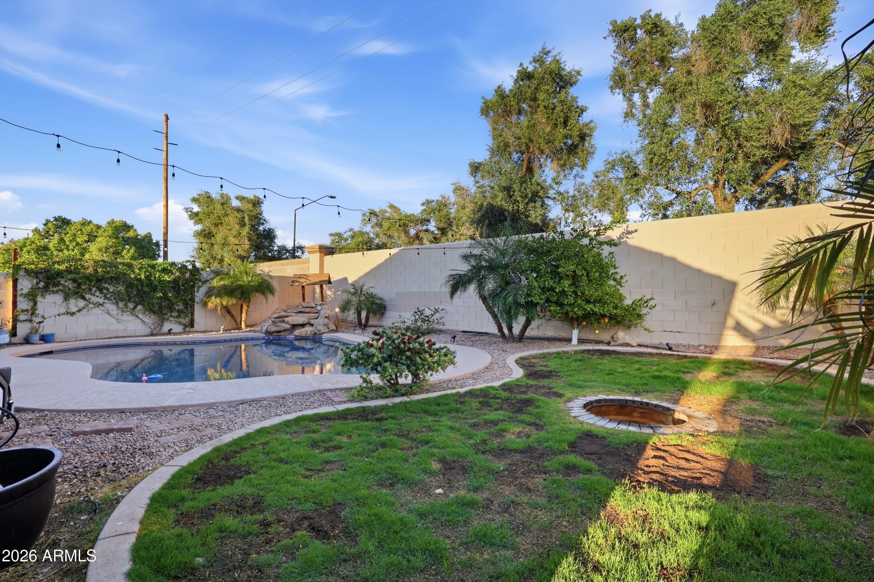 661 North Joshua Tree Lane Gilbert, AZ 85234 - Photo 31 of 47 a view of a garden with a patio
