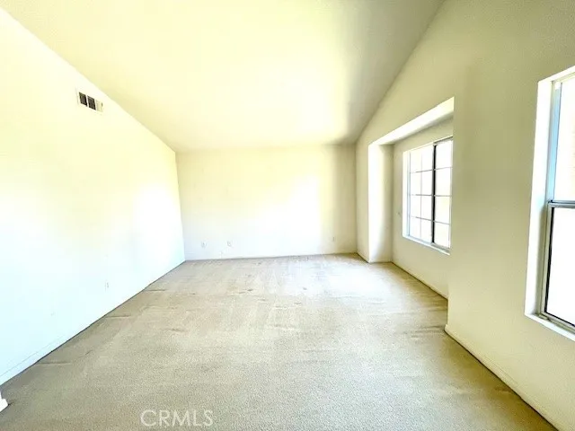 a view of an empty room with windows