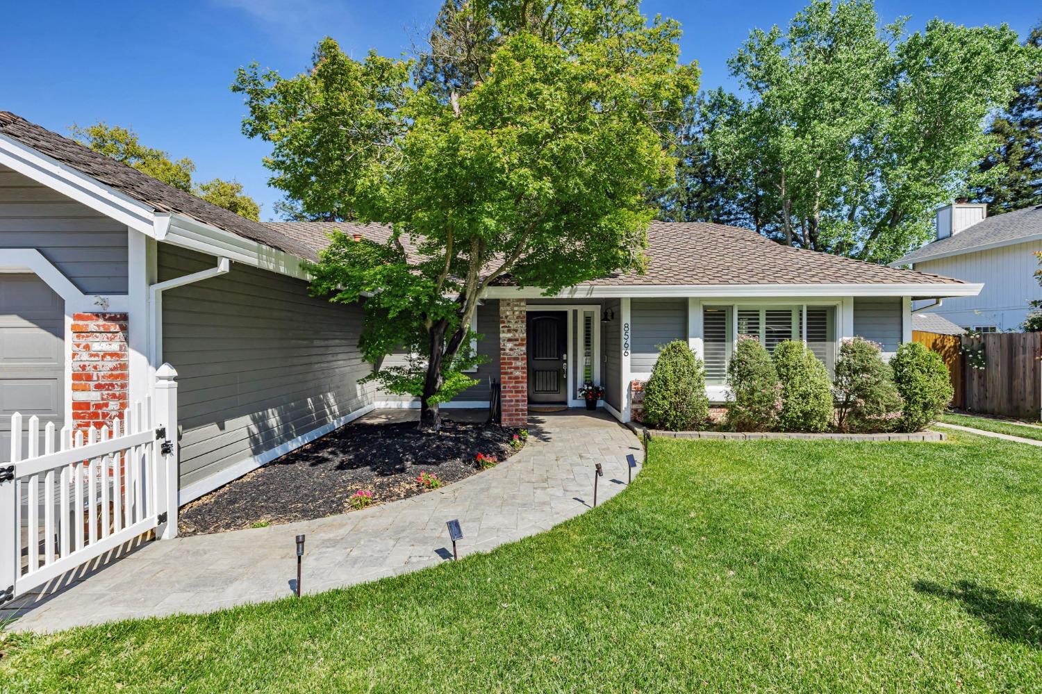 a view of a house with a yard and sitting area