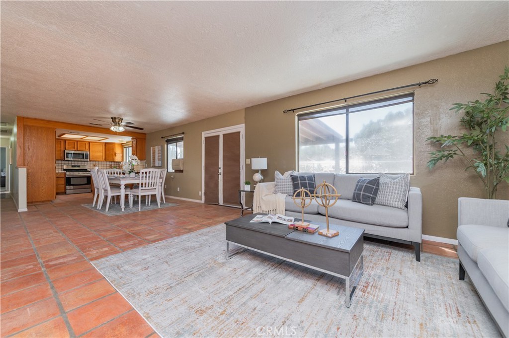 1181 Barkley Ranch Road Pinon Hills, CA 92372 - Photo 20 of 37 a living room with furniture and a table with wooden floor