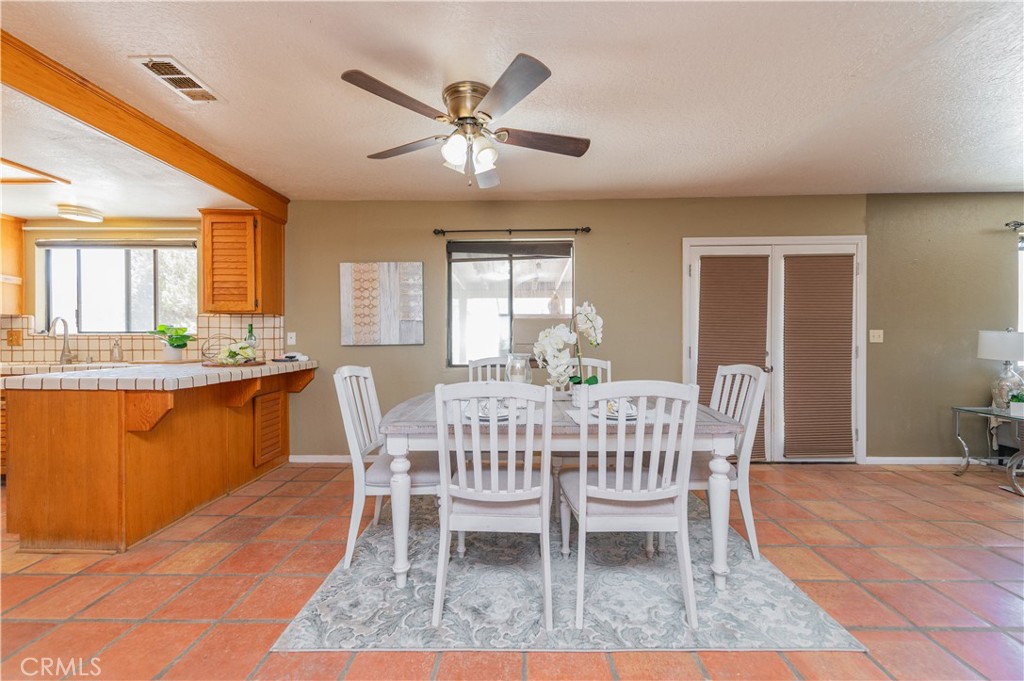1181 Barkley Ranch Road Pinon Hills, CA 92372 - Photo 22 of 37 a dining room with furniture a window and wooden floor