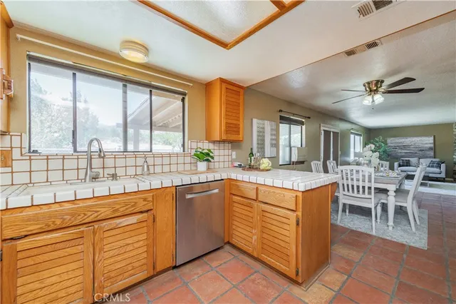 a kitchen with stainless steel appliances granite countertop a stove and a refrigerator