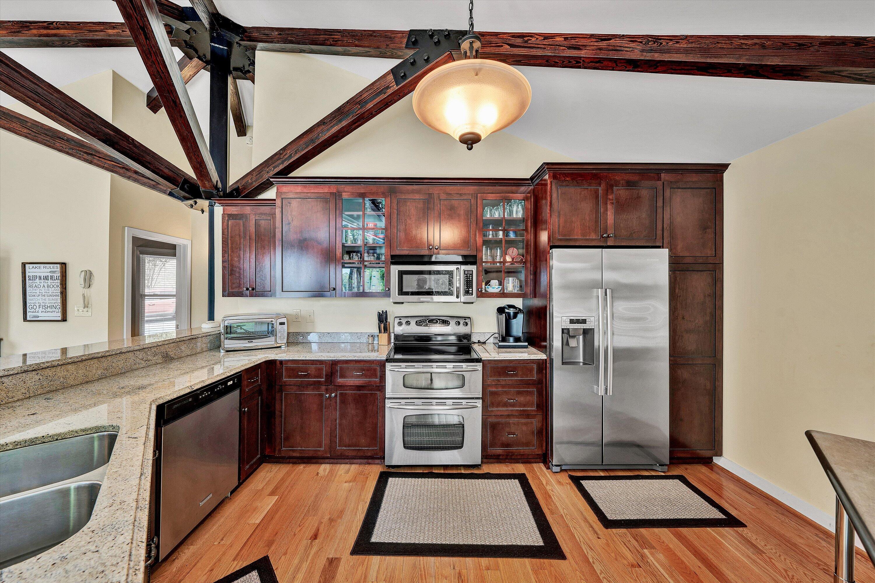 207 Winding Way Union Hall, VA 24176 - Photo 13 of 60 a kitchen with stainless steel appliances granite countertop a stove a sink and a refrigerator