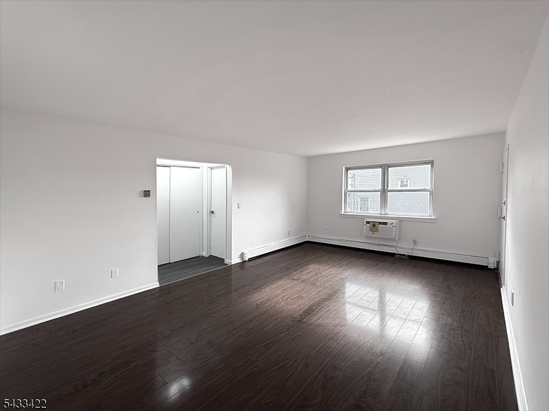 19 Van Rensselear Street, Unit 4 Belleville, NJ 07109 - Photo 5 of 10 an empty room with wooden floor and windows