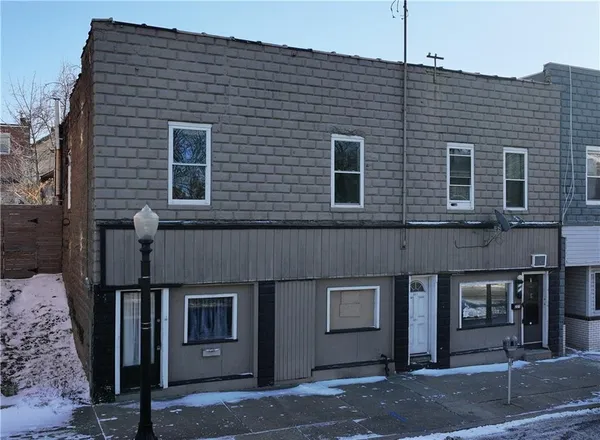 a front view of a house with a street