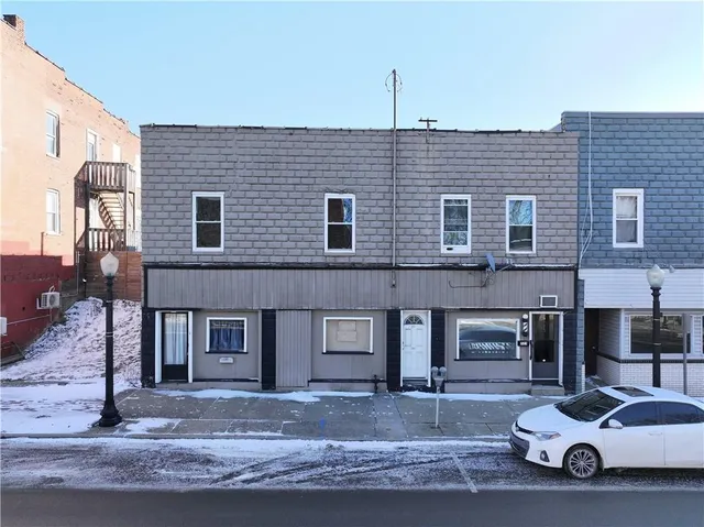 a front view of a house with parking area