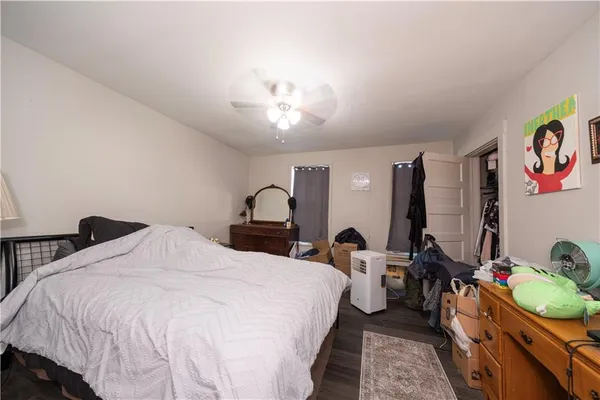 a bedroom with bed and a chandelier