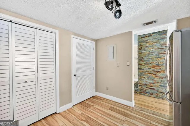 a view of a livingroom with wooden floor and a window