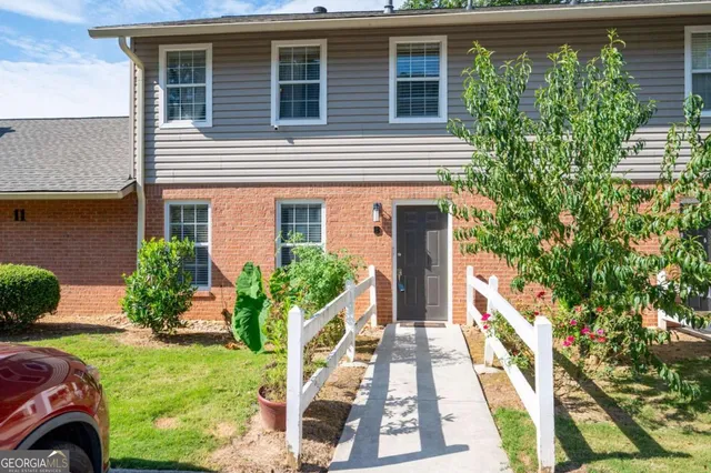 a front view of a house with garden