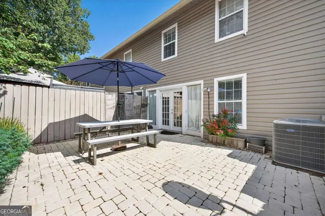 a backyard of a house with barbeque oven table and chairs