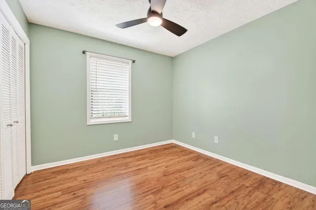 a view of a room with wooden floor and windows