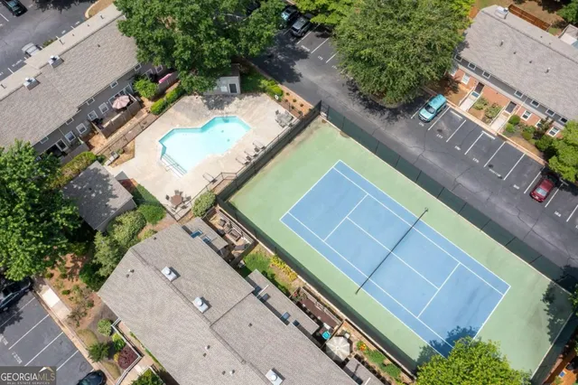 an aerial view of a tennis ground and a yard