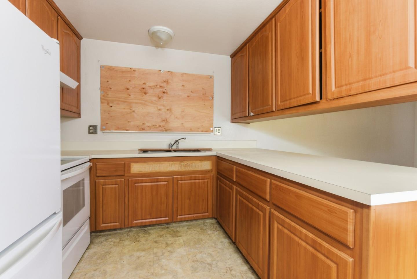1460 Mescal Street Seaside, CA 93955 - Photo 11 of 24 a kitchen with stainless steel appliances granite countertop a sink and cabinets with wooden floor