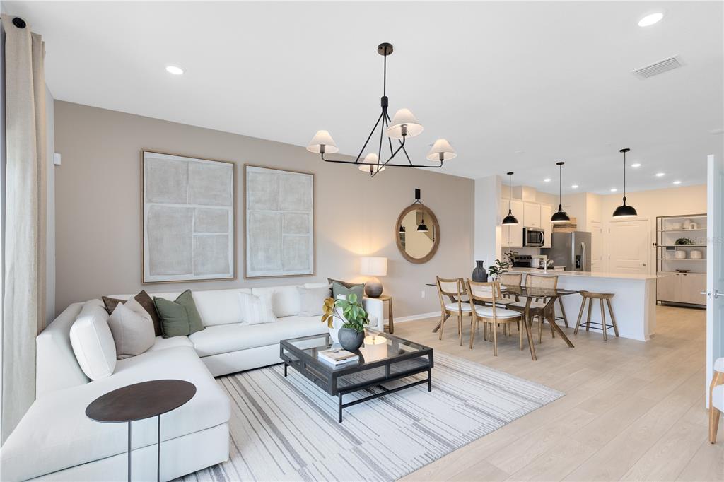 4402 Jetty Lane Palm Bay, FL 32905 - Photo 15 of 32 a living room with furniture kitchen view and a chandelier