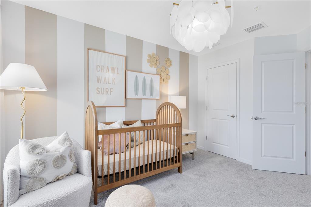 4402 Jetty Lane Palm Bay, FL 32905 - Photo 30 of 32 a bedroom with furniture and a chandelier