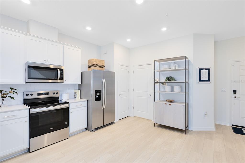 4402 Jetty Lane Palm Bay, FL 32905 - Photo 5 of 32 a kitchen with stainless steel appliances a refrigerator stove and microwave
