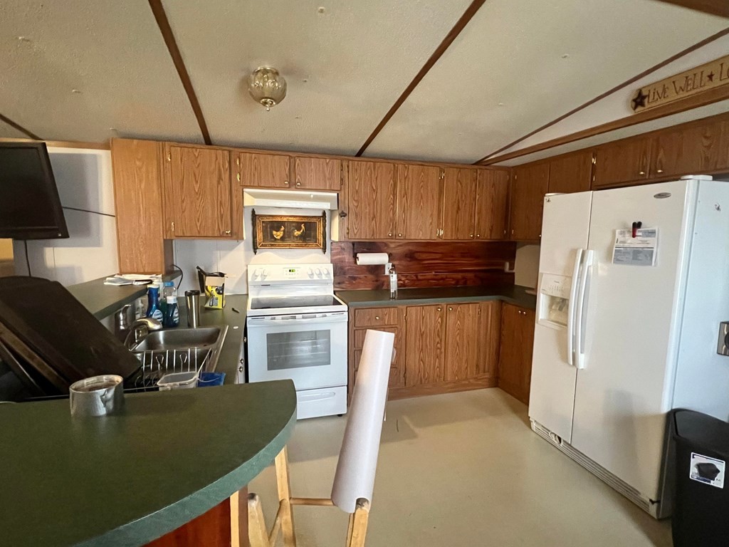 1148 Keith Valley Road Southeast Cleveland, TN 37323 - Photo 5 of 39 a kitchen with refrigerator cabinets and a table