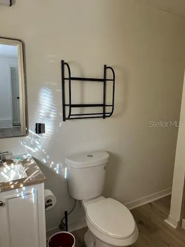 a white toilet sitting next to a shower