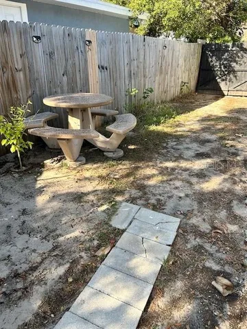 a view of a backyard with wooden fence