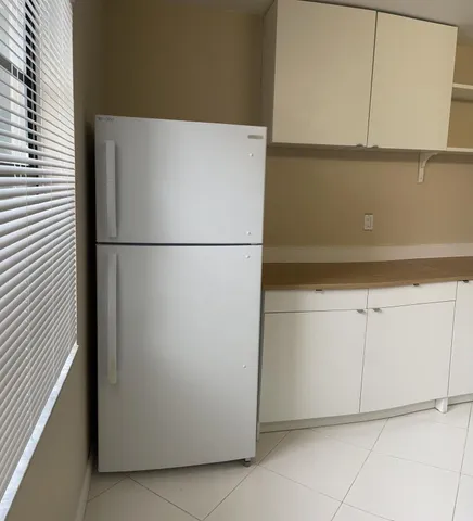 a white refrigerator freezer sitting in a kitchen