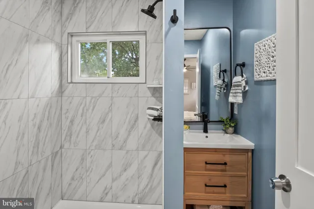 a bathroom with a double vanity sink and a mirror