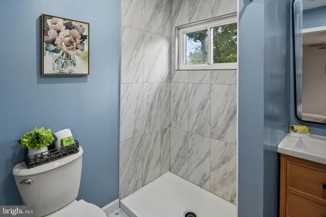 a bathroom with a toilet and a shower curtain