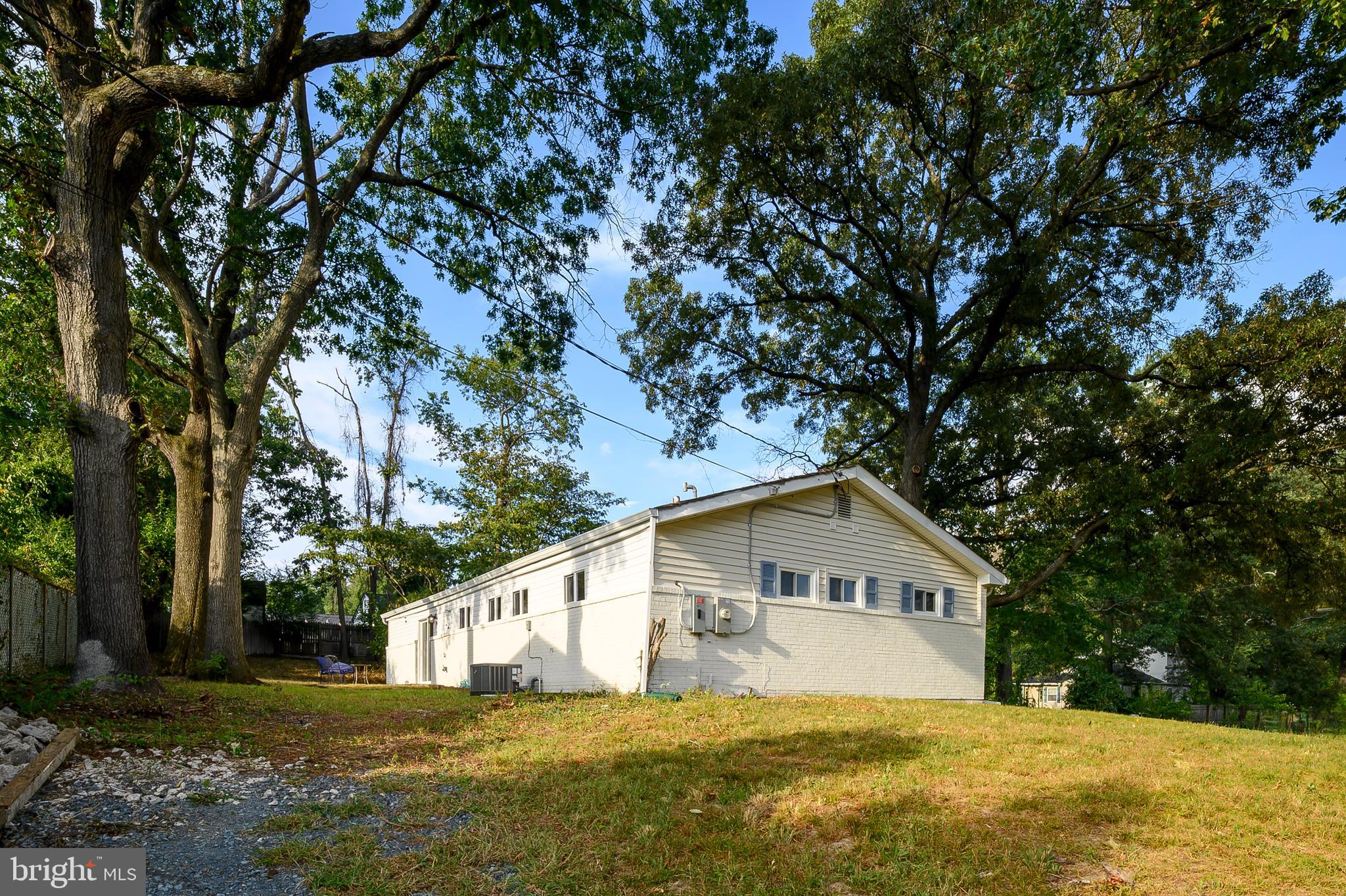 7966 Foster Avenue Severn, MD 21144 - Photo 22 of 25 a house that is sitting in middle of the yard