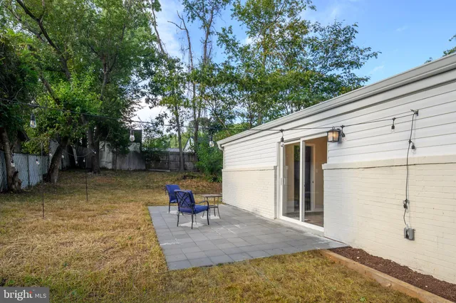 a backyard of a house with outdoor seating