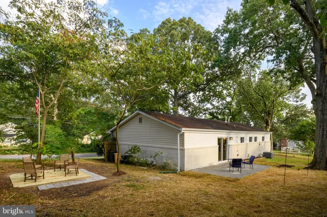 a backyard of a house with yard and outdoor seating