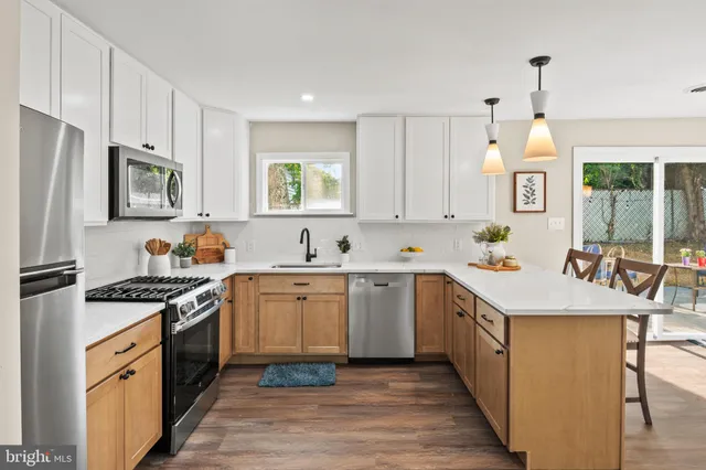 a kitchen with a sink stove top oven and refrigerator