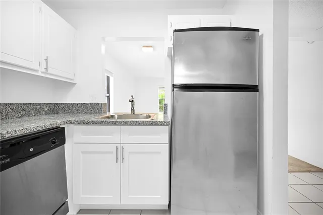 a kitchen with a refrigerator and cabinets