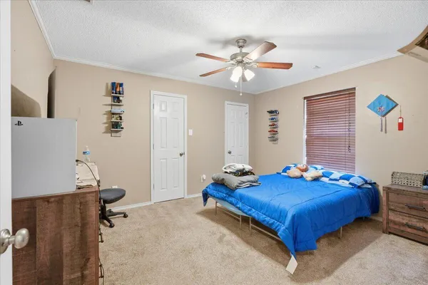 a bedroom with a bed and a chandelier