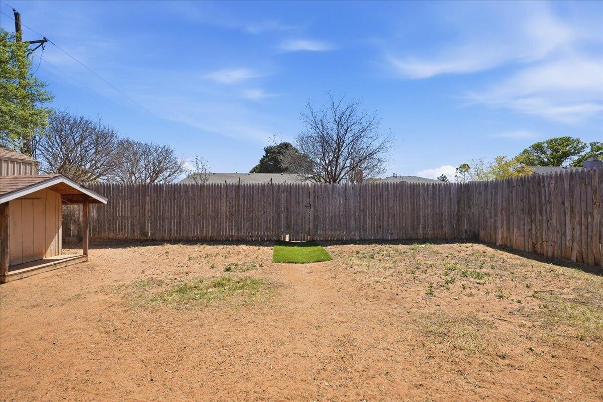 2101 76th Street Lubbock, TX 79423 - Photo 20 of 20 a view of wooden fence with a yard