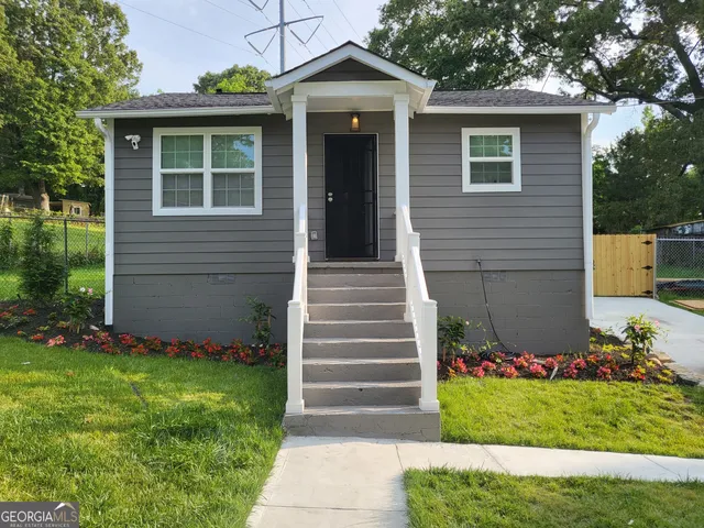 a front view of a house with garden