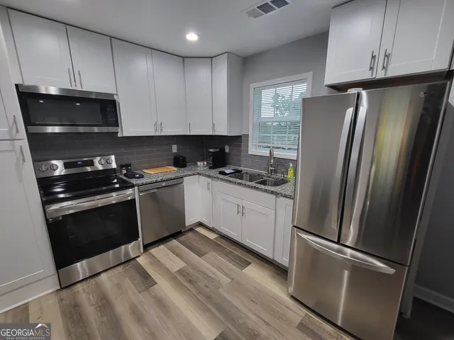 a kitchen with a refrigerator stove and sink