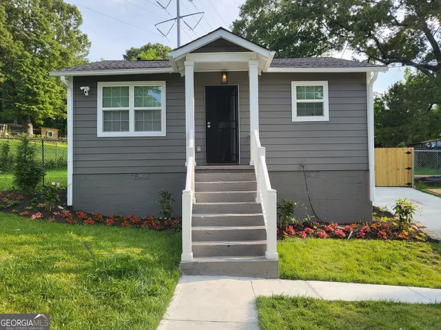 a front view of a house with garden