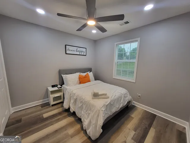 a bedroom with a bed and a window