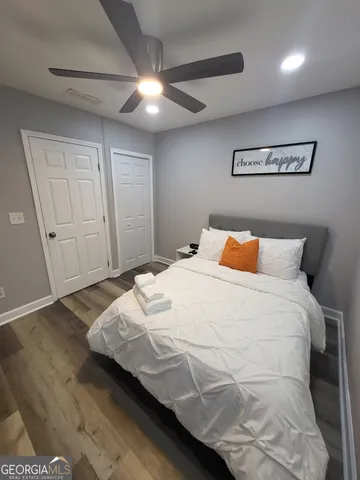 a bed sitting in a bedroom and night stand