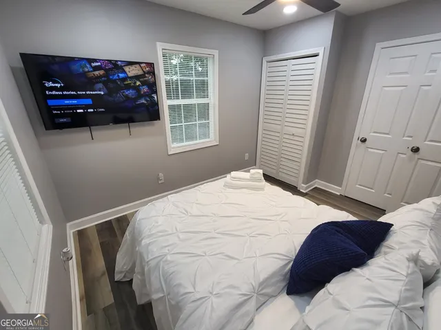 a bedroom with a bed and a window