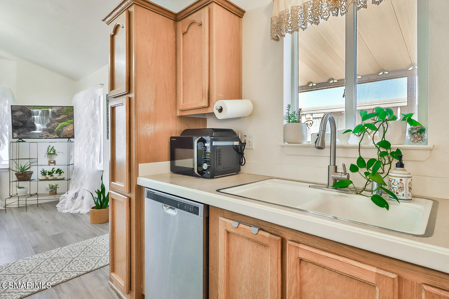 2168 Thrush Avenue, Unit 2168J Oxnard, CA 93033 - Photo 14 of 37 a kitchen with stainless steel appliances a counter space and a potted plant